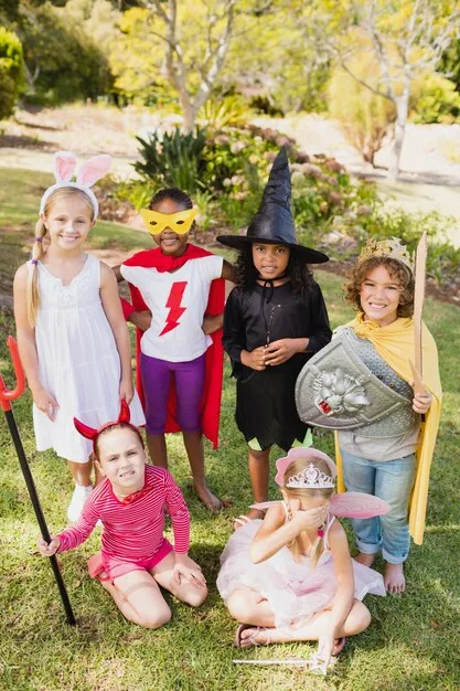 A group of children laughing and engaging in imaginative play with a set of dress-up clothes and accessories. Focus on the diversity of the costumes and the children's expressions of joy.