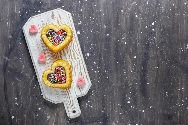 An overhead shot of a batch of shortbread cookies arranged on a wooden cutting board, some decorated with icing and sprinkles.