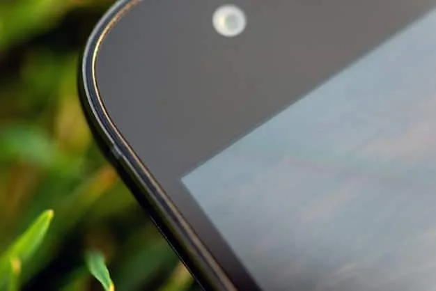A close-up shot of a foldable smartphone displaying a high-resolution image, emphasizing its flexible screen and seamless design. The background is blurred to focus on the phone's innovative features.