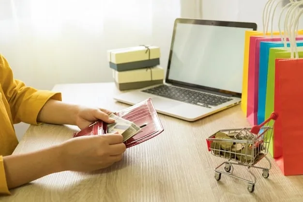 A person writing down their online shopping budget in a notebook, with a laptop open in the background showing an online store.