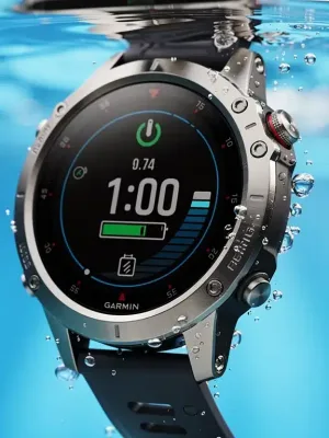 Garmin Fenix 8 smartwatch displaying diving depth and battery life on its AMOLED screen in water.