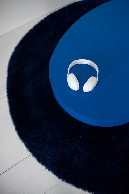 Zoomed-in shot of the earcups of the SonicSerenity Elite headphones, showcasing the plush cushioning and ergonomic design. The background is a blurred office environment with soft lighting.