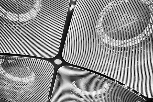 A close-up shot of a 4K projector lens projecting a test pattern with varying brightness and contrast levels onto a screen, showcasing the projector's ability to produce deep blacks and bright whites.