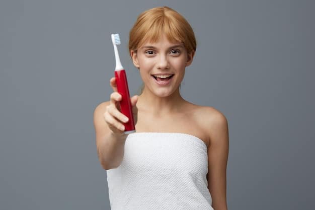 A person holding and using the Philips Sonicare DiamondClean Smart 9750 electric toothbrush in front of a bathroom mirror. The toothbrush is positioned against their teeth, showing the angle and coverage of the bristles.