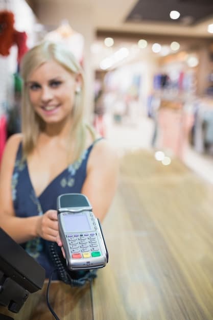 A person using a smartphone to scan a QR code at a store checkout, with the cashier and other shoppers in the background. The image shows the use of technology in modern budget shopping.