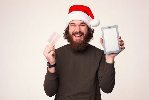 A person smiling and holding up a credit card with a holiday-themed design, symbolizing smart financial planning and preparation for holiday shopping. The image conveys a sense of readiness and confidence.