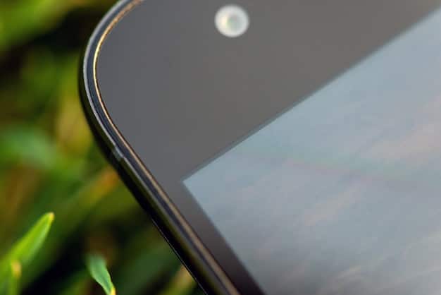 A close-up shot of a foldable smartphone displaying a high-resolution image, emphasizing its flexible screen and seamless design. The background is blurred to focus on the phone's innovative features.
