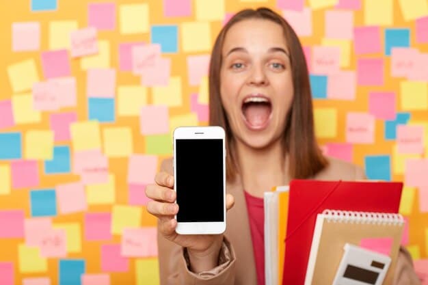 A person excitedly holding a smartphone displaying an email with the subject line 