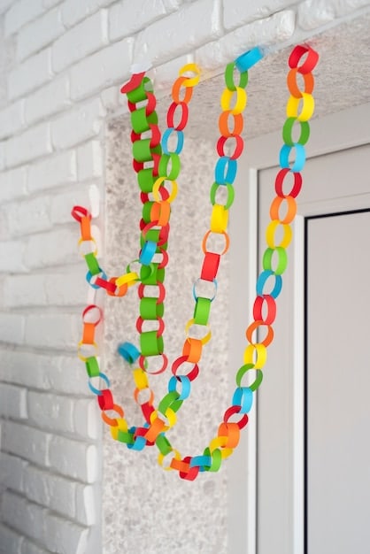 A close-up shot of a DIY holiday garland made from colorful paper and string, hanging across a doorway. The garland adds a festive and personalized touch to the home decor.