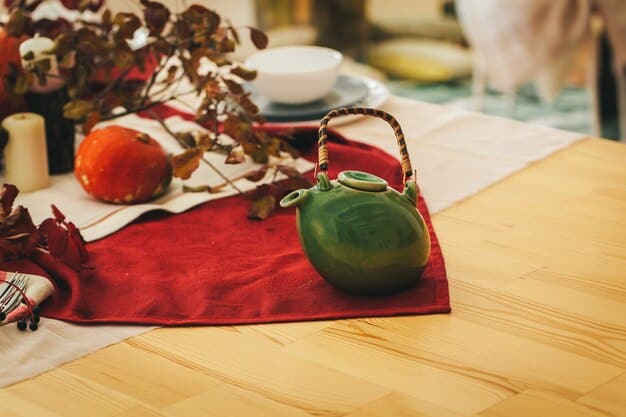A kitchen island decorated with a festive holiday table runner, seasonal placemats, and a bowl of colorful holiday-themed dish towels. The scene creates a warm and inviting cooking space.